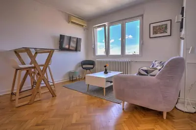 a living room with a couch and a table at Belgrade Central Apartment in Belgrade