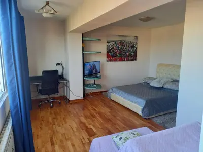 a bedroom with a bed and a desk and a chair at Top Studio in Belgrade