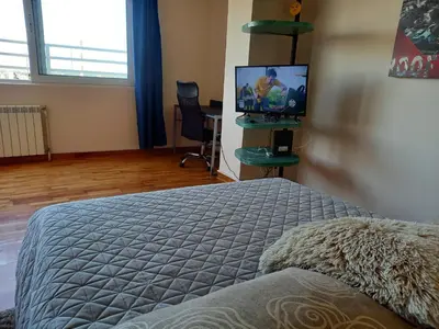 a bedroom with a bed and a flat screen tv at Top Studio in Belgrade
