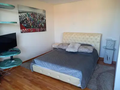 a bedroom with a bed and a flat screen tv at Top Studio in Belgrade