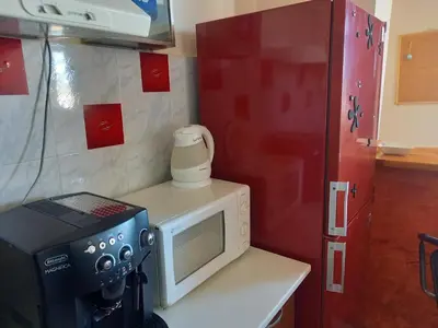 a small kitchen with a microwave and a stove at Top Studio in Belgrade