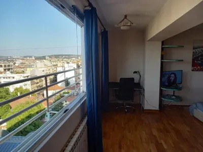 a room with a desk and a window with a view at Top Studio in Belgrade