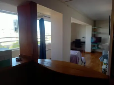 a living room with a large window and a table at Top Studio in Belgrade