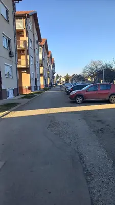 a street with cars parked on the side of the road at Apartman DUDA Surčin in Surčin