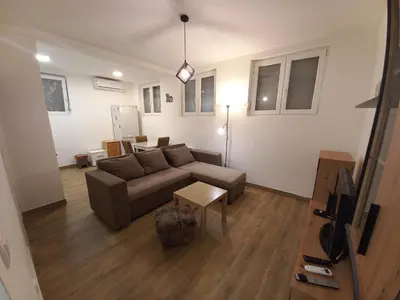 a living room with a couch and a table at Apartman DUDA Surčin in Surčin