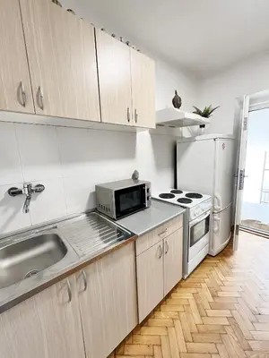 a kitchen with a sink and a microwave at Fully Equipped - Cozy & Convenient City Apartment in Belgrade
