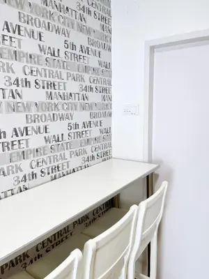 a dining room with a white table and two white chairs at Fully Equipped - Cozy & Convenient City Apartment in Belgrade