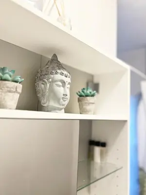 a bust of a head on a shelf with plants at Fully Equipped - Cozy & Convenient City Apartment in Belgrade