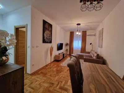 a living room with a couch and a table at Anči apartmani in Belgrade