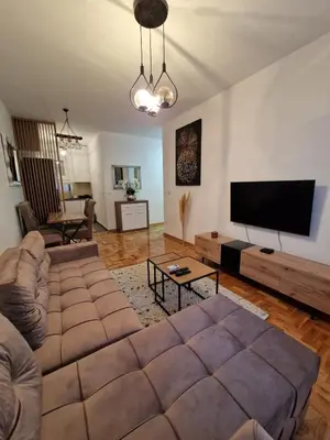 a living room with a couch and a flat screen tv at Anči apartmani in Belgrade