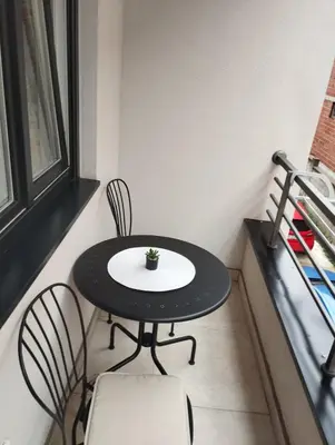 a small black table and chairs in a small room at DomaćIN in Ledine