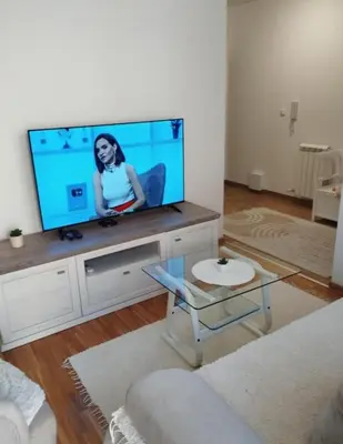 a living room with a large flat screen tv at DomaćIN in Ledine