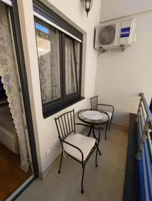 two chairs and a table in a room with a window at DomaćIN in Ledine