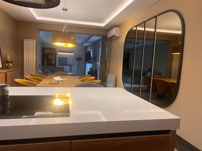 a kitchen and living room with a mirror at Autokomanda Large Family Apartment in Belgrade