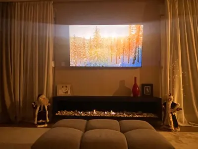 a living room with a couch and a fire place at Autokomanda Large Family Apartment in Belgrade