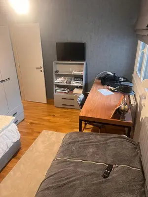 a room with a bed and a desk with a television at Autokomanda Large Family Apartment in Belgrade