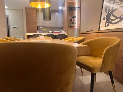 a dining room with a table and yellow chairs at Autokomanda Large Family Apartment in Belgrade