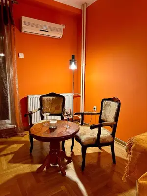 a living room with a table and two chairs at Urban Nest - Orange in Belgrade