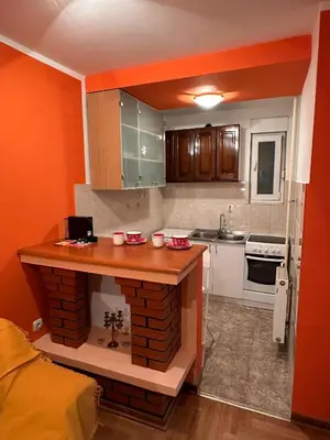 a small kitchen with a island in the middle at Urban Nest - Orange in Belgrade
