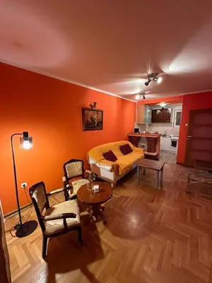 a bedroom with orange walls and a bed and a table at Urban Nest - Orange in Belgrade