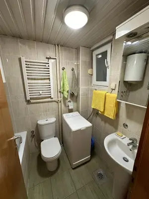 a small bathroom with a toilet and a sink at Urban Nest - Orange in Belgrade