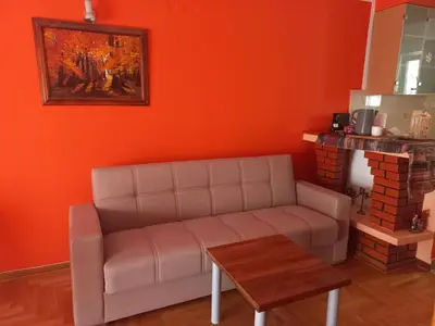 a living room with a couch and a table at Urban Nest - Orange in Belgrade