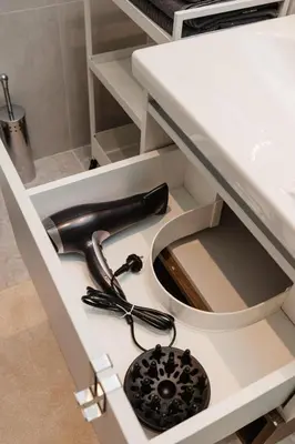 a kitchen sink with a hair dryer in a drawer at Studio Passion-Belgrade Waterfront in Belgrade
