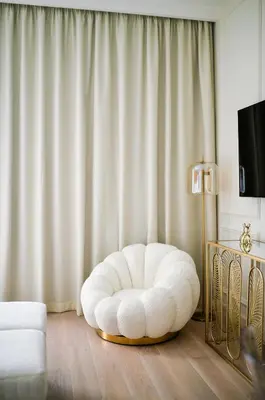 a white bean bag chair in a living room at Studio Passion-Belgrade Waterfront in Belgrade