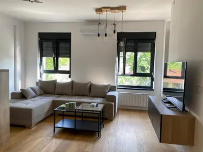 a living room with a couch and a table at Viskra in Belgrade