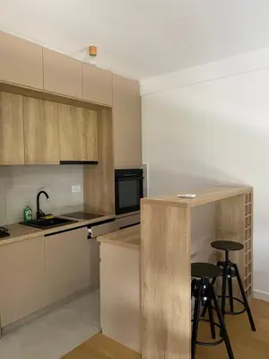 a kitchen with a counter and stools in it at Viskra in Belgrade
