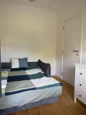 a bedroom with a bed with a dresser and a closet at Viskra in Belgrade