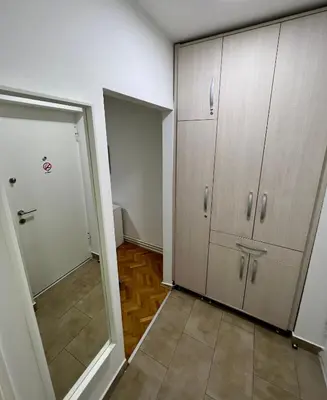 an empty room with cabinets and a door to a hallway at Cozy Apartment in Belgrade Downtown in Belgrade