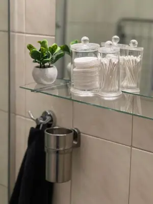 a glass shelf in a bathroom with a towel at Cozy Apartment in Belgrade Downtown in Belgrade
