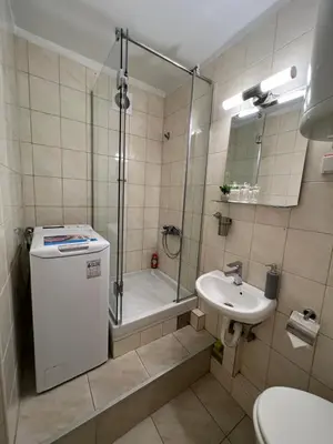 a bathroom with a shower and a toilet and a sink at Cozy Apartment in Belgrade Downtown in Belgrade