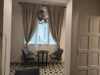 a room with two chairs and a table and a window at Cosy City Hideway in Belgrade