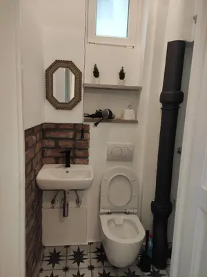 a small bathroom with a toilet and a sink at Cosy City Hideway in Belgrade