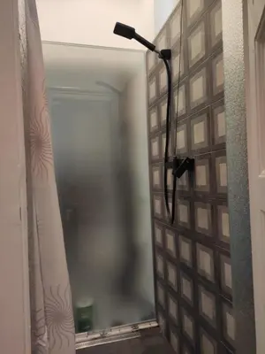 a bathroom with a mirror and a lamp on a wall at Cosy City Hideway in Belgrade