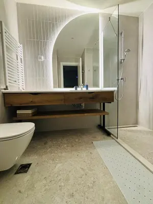 a bathroom with a sink and a toilet and a mirror at Belgrade Waterfront-Beograd na vodi Galaxy Apartment in Belgrade