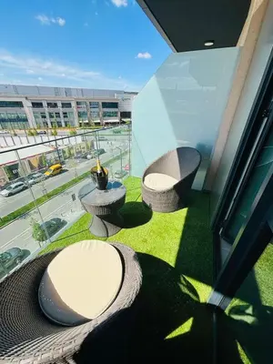a balcony with two chairs and a view of a building at Belgrade Waterfront-Beograd na vodi Galaxy Apartment in Belgrade
