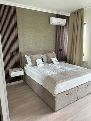 a bedroom with a large bed with two pillows at Belgrade Waterfront-Beograd na vodi Galaxy Apartment in Belgrade