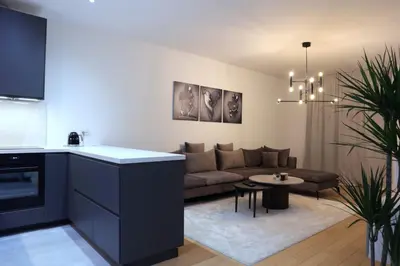 a kitchen and living room with a couch and a table at Cityheart St. Sava in Vračar (historical)