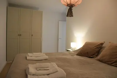 a bedroom with two towels on a bed at Cityheart St. Sava in Vračar (historical)