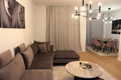 a living room with a couch and a table at Cityheart St. Sava in Vračar (historical)