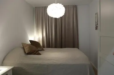 a bedroom with a bed and a chandelier at Cityheart St. Sava in Vračar (historical)
