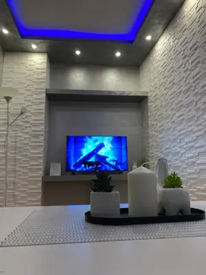 a living room with a flat screen tv on a wall at Play Apartman Obrenovac in Obrenovac