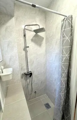 a shower with a glass door in a bathroom at Golden Oasis in Belgrade