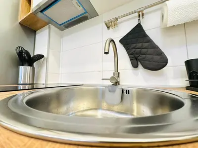 a kitchen sink with a faucet on a counter at Golden Oasis in Belgrade