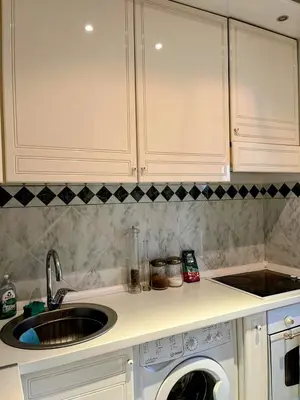 a kitchen with a sink and a washing machine at St. Mark in Belgrade