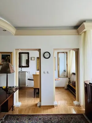 a living room with a clock on the wall at St. Mark in Belgrade