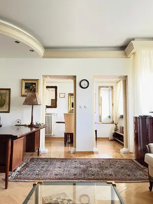 a living room with a clock on the wall at St. Mark in Belgrade